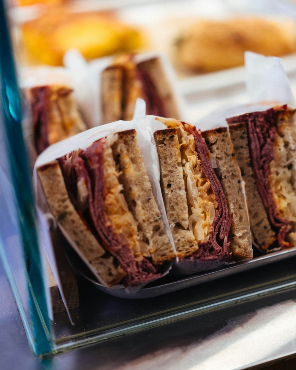 Fresh barms and filled rolls lined up along the BARM counter, ready to be boxed up.